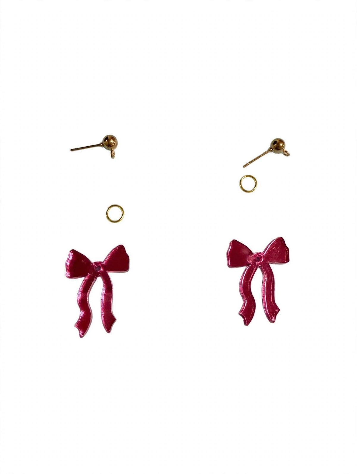 A pair of dangling bow earrings with deep pink mirror bows and gold-tone posts and backing rings, shown against a plain white background.